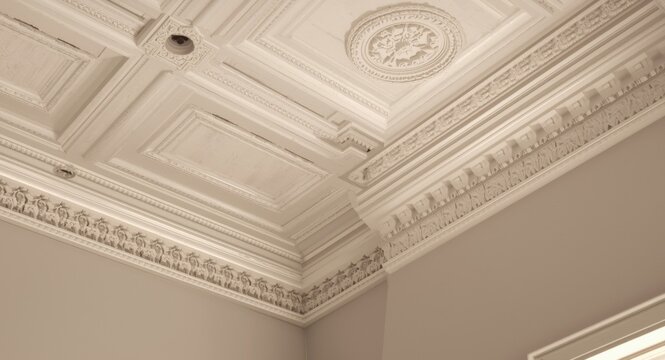 Decorative white crown trims for angular ceiling frameworks