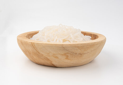 Shirataki or konnyaku pasta in wood bowl isolated. Konjak jelly noodles, Japanese zero calorie sirataki