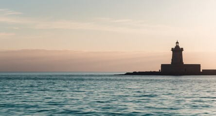 Fototapeta premium Gentle sea horizon accented by a stone tower silhouette
