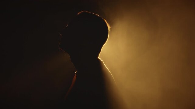 Mysterious Man speaking in studio Smoke set, Golden scenic Silhouette details
