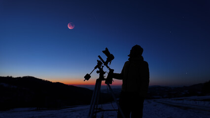 Amateur astronomer observing stars, planets, Moon eclipse and other celestial objects. © astrosystem