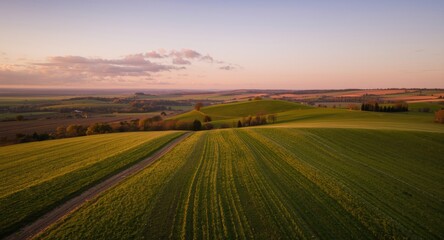 Fototapeta premium Beautiful meadow and farmland landscape captured at dusk from above