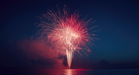 Obraz premium Festive fireworks glowing with red and white brilliance in a midnight blue sky setting for party scenes