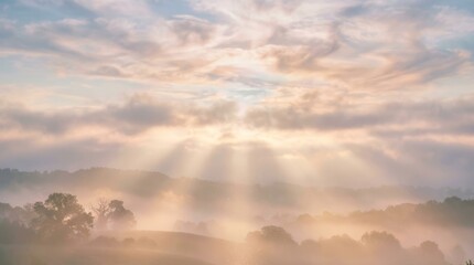 Fototapeta premium Sunbeams piercing through foggy hills at sunrise