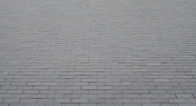 gray toned brick pavement with linear rectangular block pattern