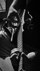 Electric Guitar Player Hands Close-Up in Dramatic Black and White