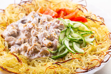 Chicken thighs cooked in creamy mustard sauce with potatoes, mushrooms and fresh vegetables, comfort food dish.