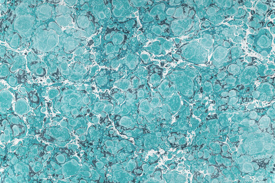 Light blue marble paper creating abstract fluid texture background