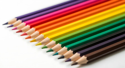 Fototapeta premium Colorful pencils arranged in a rainbow pattern on white background with soft lighting