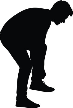 Man bending down in contemplation or sorrow captured in a silhouette artwork from a side profile view