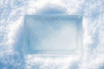 Ice block in the light blue tones on white fluffy snow background.