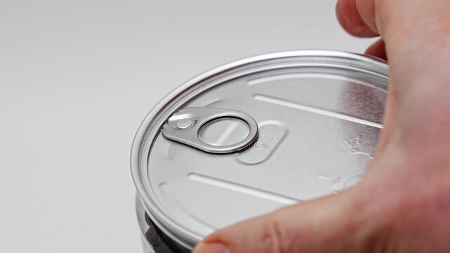 Opening a can of mixed five peppers in a simple kitchen