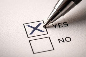 Close-up of a checkbox marked yes with a pen