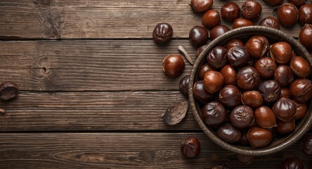 copy space image with fresh chestnuts arranged in a bowl on rustic barn wood background