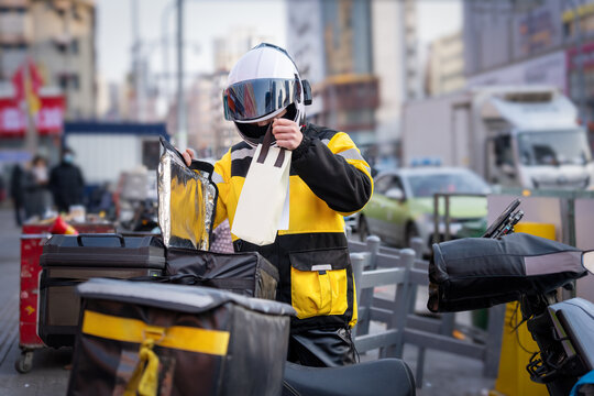 Delivery Worker in Yellow Uniform with Helmet