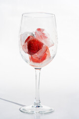 Fruits in a clear glass  on a white background