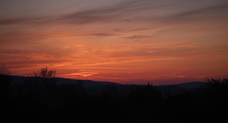 Fototapeta premium Evening sky glowing with warm sunset hues during seasonal change