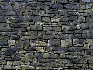 Obraz premium Distressed Blackened Limestone Wall with Patina