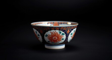 Historic Japanese Imari porcelain rice bowl on subtle out of focus black background