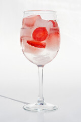 Fruits in a clear glass  on a white background