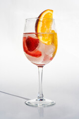 Fruits in a clear glass  on a white background