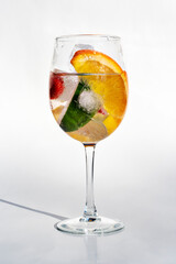 Fruits in a clear glass  on a white background