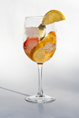 Fruits in a clear glass  on a white background