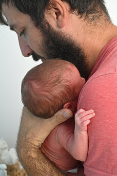 Infant in his father's arms in a moment of tenderness