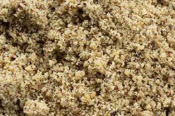 Detailed texture background of ground walnut kernels