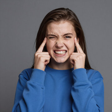 Teenage girl in blue sweatshirt, making funny grimaces