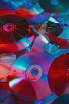 Vivid collection of colorful compact discs with reflective surfaces and abstract lighting Grain and noise