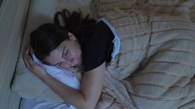 Content Woman Getting Ready for Sleep in a Cozy Bedroom at Night
