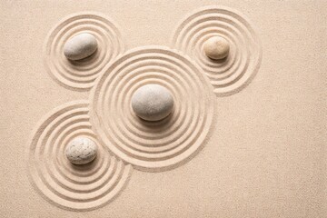 Naklejka premium Zen garden with smooth stones and concentric sand circles symbolizing peace, focus, harmony and balance