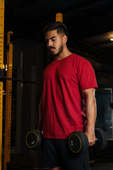 Focused Young Man Holding Dumbbells During Strength Workout