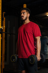 Focused Young Man Holding Dumbbells During Strength Workout
