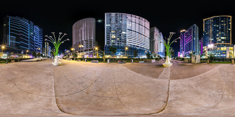 night panorama 360 near skyscraper multistory buildings with illumination of residential quarter complex in full equirectangular seamless spherical projection
