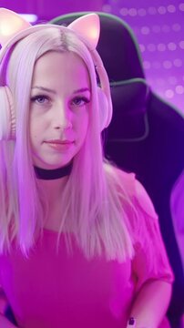 Cute Gamer Girl with cat ears headphones show the middle finger at camera