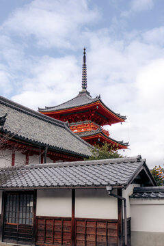 Traditional Japanese pagoda with gray tiled roofs and a cloudy sky. Kyoto, Japan