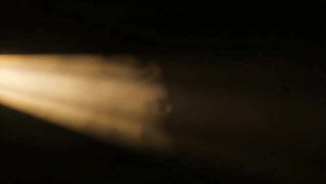 Golden light beam illuminating dust particles in darkness, creating a dramatic atmospheric effect