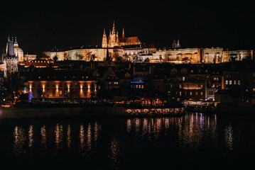 Fototapeta premium Beautiful night cityscape of Prague with Vltava river. St Vita Cathedral.