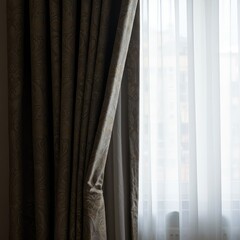 Elegant window treatment featuring heavy drapes and sheer panels, highlighting the renewed focus on detailed textile home decoration ,living room ,design ,elegant