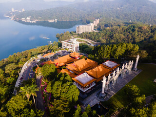 High-angle aerial close-up of Wen Wu Temple at Sun Moon Lake, Taiwan, highlighting ornate rooftops, colorful details, and layered traditional Chinese architecture against the lake and forest backdrop.