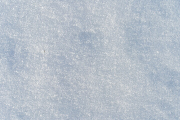 Obraz premium Natural snow texture with fine ice crystals creating a clean winter background. Minimal surface with copy space suitable for seasonal design, cold climate concepts and abstract winter visuals. 