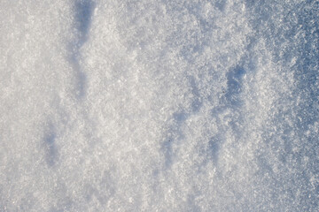 Obraz premium Natural snow texture with fine ice crystals creating a clean winter background. Minimal surface with copy space suitable for seasonal design, cold climate concepts and abstract winter visuals. 