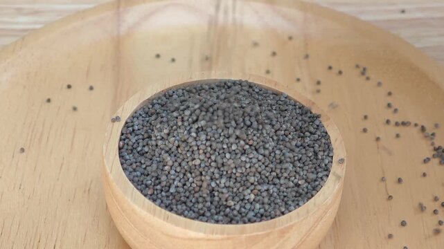 Grains and sesame seeds in a wooden bowl.