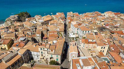 Naklejka premium Aerial view of the main street in the historic center of Tropea, Calabria, Italy. It is a small town and a famous tourist destination overlooking the Mediterranean sea. In background is the Sanctuary.