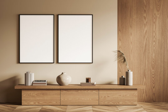 Two blank vertical posters in modern minimalist interior, wooden console with books and vases, on beige and wood panel wall. 3D Rendering