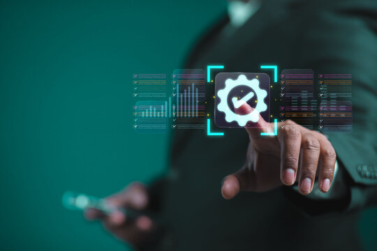 The businessman displays an interface showing digital quality assurance and certification symbols, representing high standards, ISO compliance, and professional business excellence.