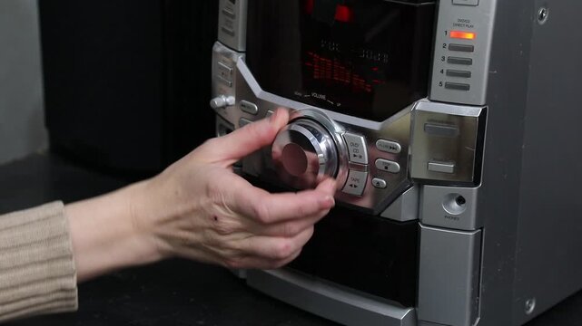 rustle of the volume control dial of the music system