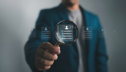 Magnifying glass focuses on a resume with checkmarks, signifying recruitment and hiring process